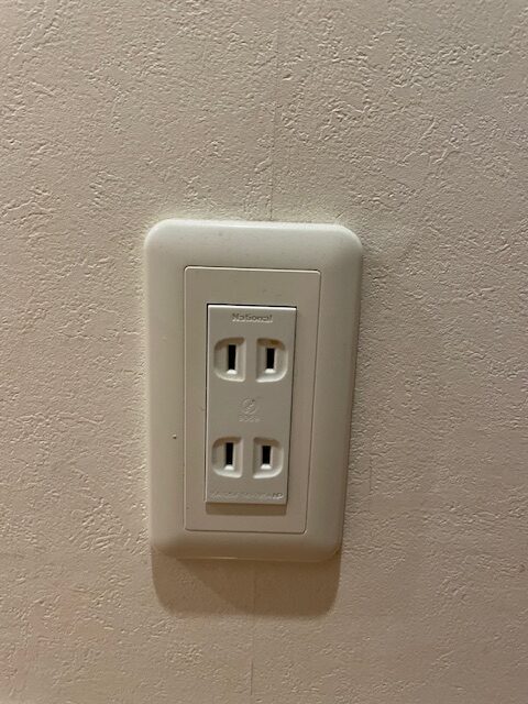 A typical wall outlet in Japan. There is no polarized prong nor earth.  US plugs normally have no problem using a Japanese outlet.